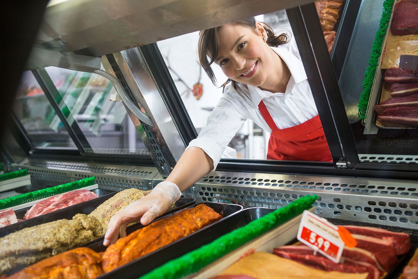 Clerk Reaching into Deli Case